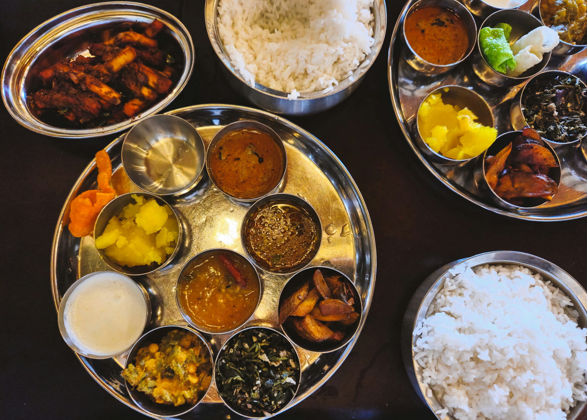 Vegetarian Indian thalis served with rice and side dishes